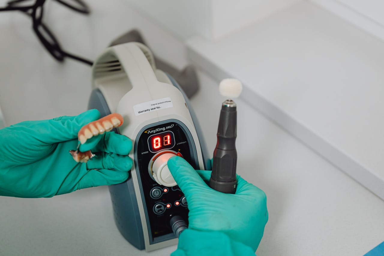 certified dental lab technician repairing denture